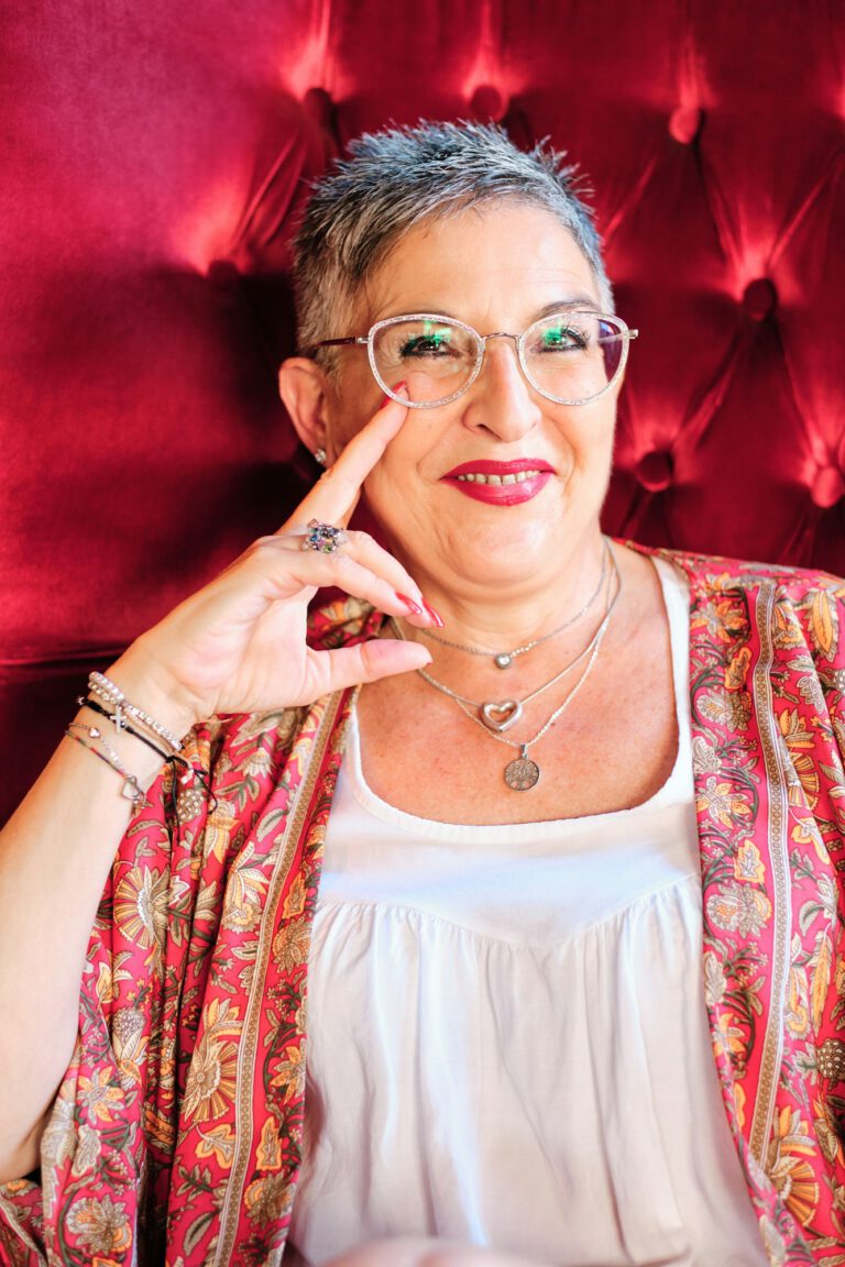 adult confident woman with grey hair looking at camera and smiling